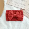 Diadema roja para bebé con lazo de punto trenzado en nailon elástico suave - Estilo de Lazo Torcido / Rojo Oscuro