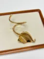 Close-up view of the vintage gold metallic cuff bracelet, featuring a unique spiral leaf design. - Gold Wrap Leaf Style (SL0443)