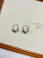 Close-up detail of silver geometric metal earrings, showcasing retro abstract design. - Fluid Geometric Style (EH2448B) / Silver