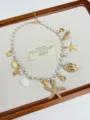 Detail view of a bohemian ocean style starfish pendant necklace with pearls and shells. - Beaded Starfish Necklace (XL3120)