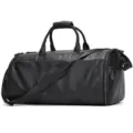 Detailed view of black leather travel duffel bag with shoulder strap and metal zippers. - Black Litchi Pattern