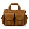 Retro brown leather briefcase detail shot showing multi-pocket design, cowhide texture. - Ribbon Edged / Tan