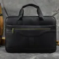 Black leather business briefcase close-up, showing detailed texture, metal zipper and handles. - 3317 / Black