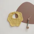 Nordic style yellow petal baby bib for newborns made of soft cotton muslin fabric - Petal Bib / Egg Yellow