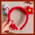 Close-up of red plush headband with cute zodiac horse and star details for festival. - Red Flower Pony