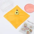 Detailed close-up of yellow coral fleece hand towel featuring cute avocado plush toy design. - Avocado / Yellow