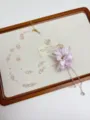 Close-up detail of the fairy resort purple flower beaded necklace with crystal charms. - Purple Flower Tassel Necklace