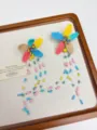 Colorful beaded flower detail earrings with long tassel drops, handmade close-up display. - Colorful Beaded Earrings