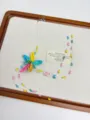 Colorful beaded flower necklace detail shot, delicate handmade design with transparent line. - Colorful Flower Beaded Necklace