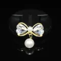 Gold bow pearl rhinestone pendant DIY craft accessory detail shot, sparkling crystal. - White
