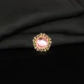 Detailed close-up of a round gold filigree alloy button with pink crystal for DIY crafts. - Light Pink