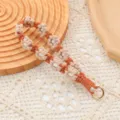 Llavero con correa para la muñeca de margarita tejida a mano en naranja y beige - Caqui
