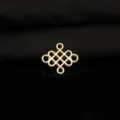 Close-up detail of the vintage gold-colored four-hole mystic knot metal DIY accessory. - 18K Gold