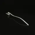 Close-up detail of the metal snake hairpin, highlighting its wavy shape and silver finish. - Silver