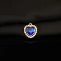Detailed close-up of blue crystal heart pendant with rhinestone halo on black background. - Sapphire Blue
