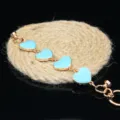 Close-up detail of DIY gold metal chain featuring cute light blue enamel heart charms. - Blue Heart