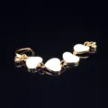 Close-up detail of gold alloy phone charm chain with white enamel heart pendants for DIY. - White Heart