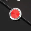Detailed close-up of red CD texture phone ring holder bracket with metallic finish. - Bright Red CD Pattern