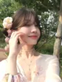 Close-up detail of the traditional style floral hair accessory with delicate tassels worn outdoors. - Tassel Side Clip / Single Piece / Single Pink Gradient Hydrangea Clip