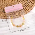 Transparent jewelry sealing bag with a pink seal and a beaded bracelet, compact size. - 10pcs/Pack / Pink (#04)