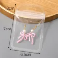 Boucles d'oreilles nœud rose perle dans sachet transparent bijoux accessoires mode - Modèle #02 / 6.5x10cm