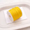 Bright yellow jade cord spool for DIY handmade braided bracelets, necklaces, and craft projects. - Yellow