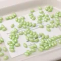 Light green glass rice beads 4x7mm solid color loose beads for DIY handmade bracelets. - 52 Pieces/Pack / Bud Green