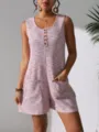 Detail of a sleeveless waffle knit romper with front buttons and pockets. - S / Tops / Pink