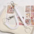 White spring coil keychain lanyard, plastic stretch cord with metal rings for keys and bags. - White