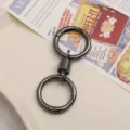 Black metal double ring keychain with spring connector, durable DIY accessory for keys. - Black