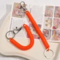 Orange coiled spring keychain lanyards with metal clasps for keys, bags and DIY crafts. - Orange