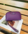 Purple genuine cowhide leather clutch wallet for women with wrist strap and metal clover detail. - Purple