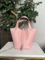 Pink leather bucket bag detail showing premium texture and silver padlock hardware. - Silver Buckle / 3Q Pink