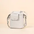 Elegant leather bucket bag with drawstring closure and crossbody strap for women daily commute. - White