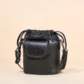 Black genuine leather drawstring bucket bag with front pocket, stylish crossbody bag. - Black
