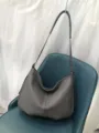Detailed shot of the grey genuine leather hobo shoulder bag, showing soft milled texture and strap. - Gray