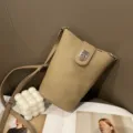 Detail shot of genuine leather mini phone crossbody bag, featuring slim strap and clasp. - Khaki