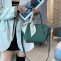Dark green genuine leather shell bag with top handle, adjustable strap and stylish silk scarf. - Almond Green