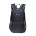 Detailed view of the black nylon folding backpack, showing front zipper pocket and texture. - Black