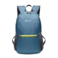 Detailed view of the blue waterproof nylon folding backpack with yellow zippers and brand logo. - Sky Blue