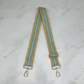 Detailed close-up of wide woven bag strap with blue yellow pattern and gold metal hardware. - Blue Yellow Fractal