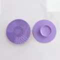 Round silicone makeup brush cleaning mat with various textures for deep cleaning tools. - Purple
