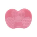 Pink silicone makeup brush cleaning mat with multiple textured areas for deep cleaning tools. - Peach Pink