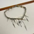 Detailed view of Y2K leopard print leather choker necklace with metal cross and spike pendants. - Main Image Necklace Style (Z-3658)