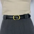 Minimalist black leather belt for women with elegant gold-toned oval buckle versatile fashion accessory - Black