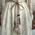 Ceinture de taille tressée bohème avec pompons glands et charms en métal vue détaillée. - Kaki