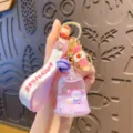 Schlüsselanhänger mit lila Flüssigkeitsglocke, rosa Band und süßem Anhänger für Taschen. - OPP-Beutel / Lila