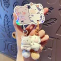 Süßer Plüsch Tier Schlüsselanhänger mit flauschigem Pompon und praktischer Geschenkkarte. - OPP-Beutel-Verpackung / Kuh und Maus