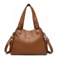 Brown PU leather tote bag detail, featuring soft texture, durable handles and metal logo. - Brown