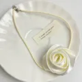 Fabric rose choker necklace detail, elegant white floral design with thin cord accessory. - Rose Choker (Z-1063) / Beige